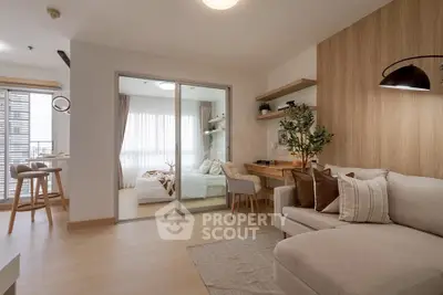 Modern living room with cozy sofa and stylish decor in open layout apartment.