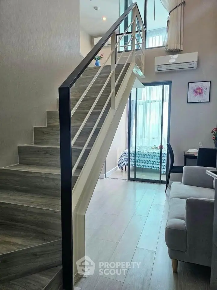Modern duplex interior with stylish staircase and cozy living area