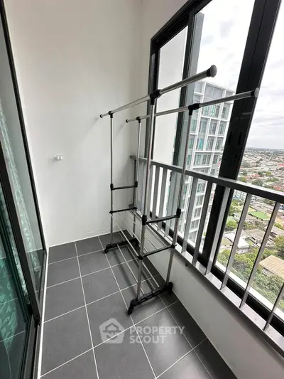 Modern balcony with city view and sleek drying rack, perfect for urban living.