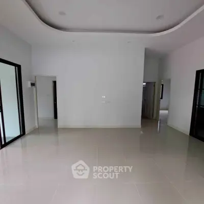 Spacious empty room with glossy tiled flooring and modern design