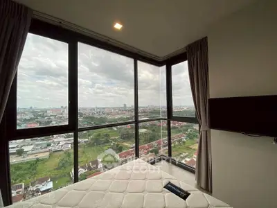 Stunning corner unit bedroom with panoramic city views and large windows.