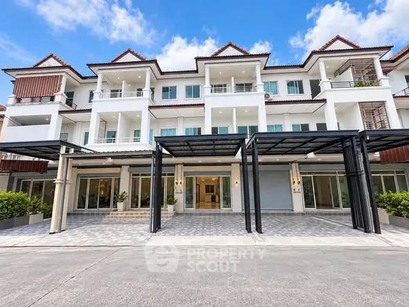 Stunning modern townhouse exterior with spacious balconies and elegant entrance.