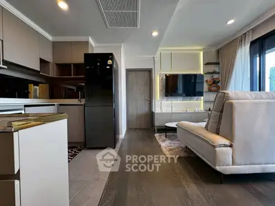 Modern living room with sleek kitchen and stylish decor