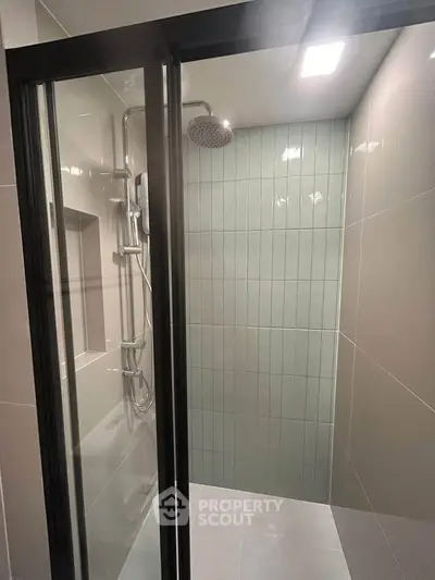 Modern bathroom shower with sleek glass door and contemporary fixtures