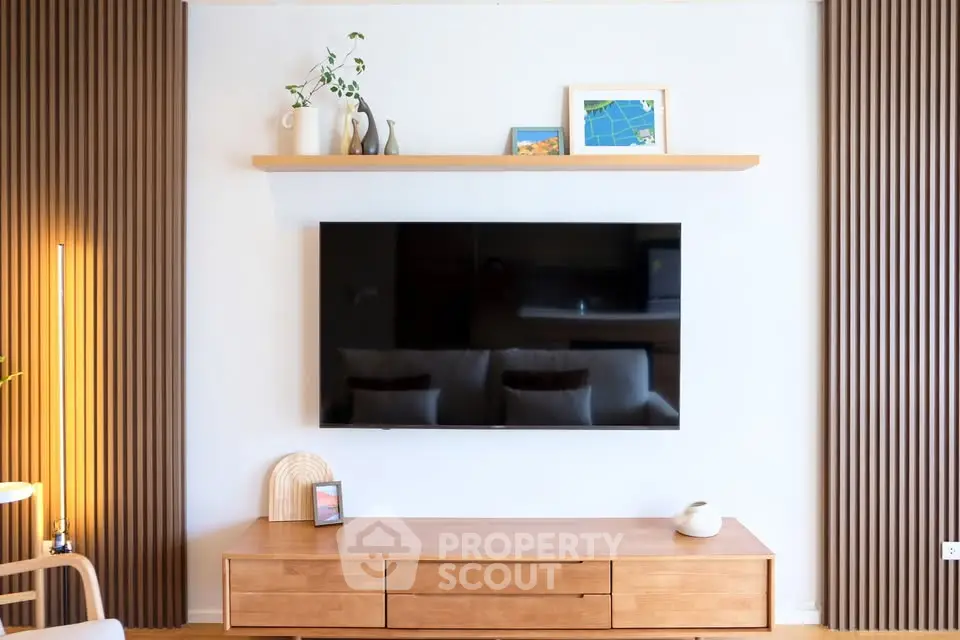 Modern living room with sleek TV setup and stylish wooden furniture
