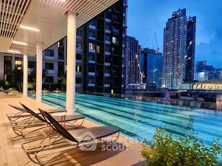 Luxurious rooftop pool with stunning city skyline views at dusk, perfect for relaxation and leisure.