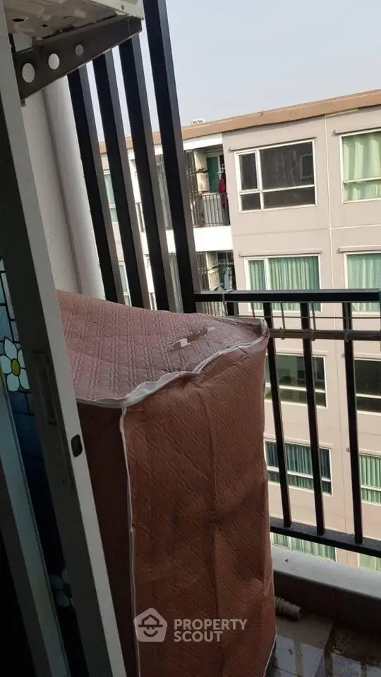 Cozy balcony view with potential for outdoor relaxation in urban apartment setting.