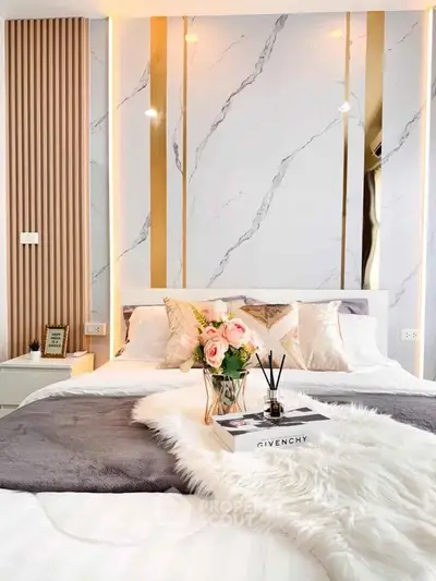 Luxurious bedroom with elegant decor and plush bedding, featuring a stylish accent wall and modern lighting.
