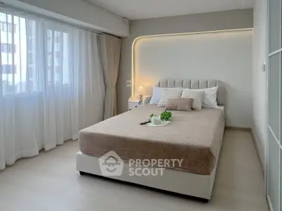 Modern bedroom with elegant lighting and cozy decor in a stylish apartment.