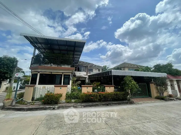 Charming suburban house with lush garden and spacious driveway under a clear blue sky.
