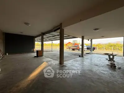 Spacious open garage with scenic vineyard view and ample natural light