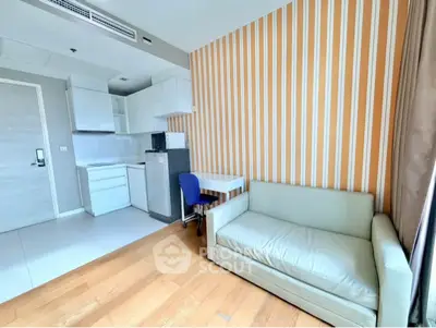 Modern studio apartment with compact kitchen and cozy living area