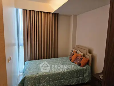 Cozy bedroom with modern decor and large window for natural light