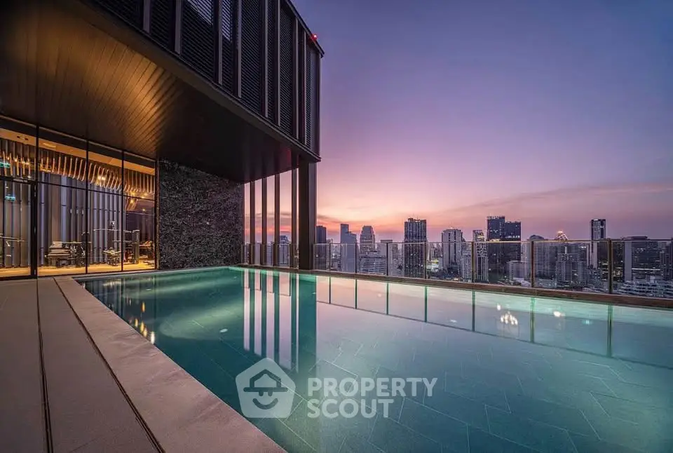 Luxurious rooftop pool with stunning city skyline view at sunset, perfect for urban living.