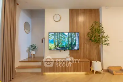 Modern living room with stylish wooden paneling and wall-mounted TV