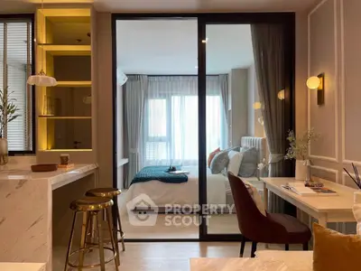 Modern open-plan living room with stylish decor and cozy bedroom view