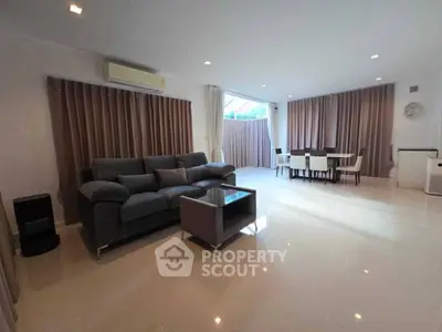 Spacious modern living room with elegant dining area and natural light