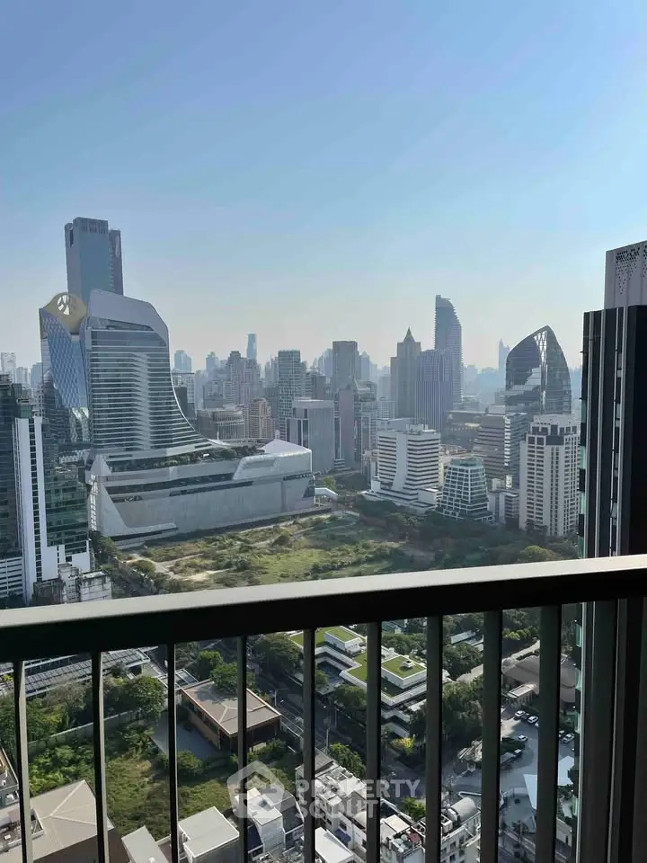 Stunning cityscape view from a high-rise balcony showcasing modern skyscrapers and urban landscape.