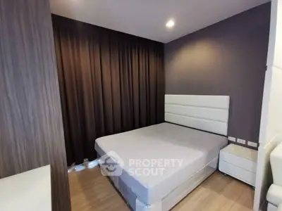 Modern bedroom with sleek design and cozy ambiance, featuring a comfortable bed and stylish decor.