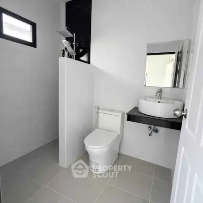 Modern minimalist bathroom with sleek fixtures and neutral tones, perfect for a contemporary home.