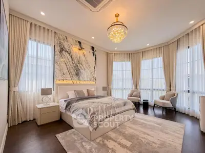 Luxurious bedroom with elegant decor and large windows for natural light