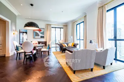 Luxurious modern living room with elegant decor and city view, featuring stylish furniture and ample natural light.