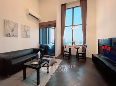 Modern living room with high ceilings, city view, and stylish decor.