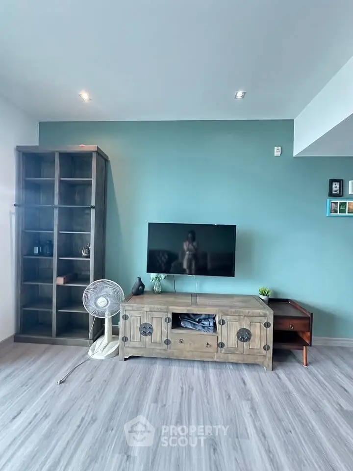 Modern living room with stylish TV stand and shelving unit, featuring a sleek design and cozy ambiance.