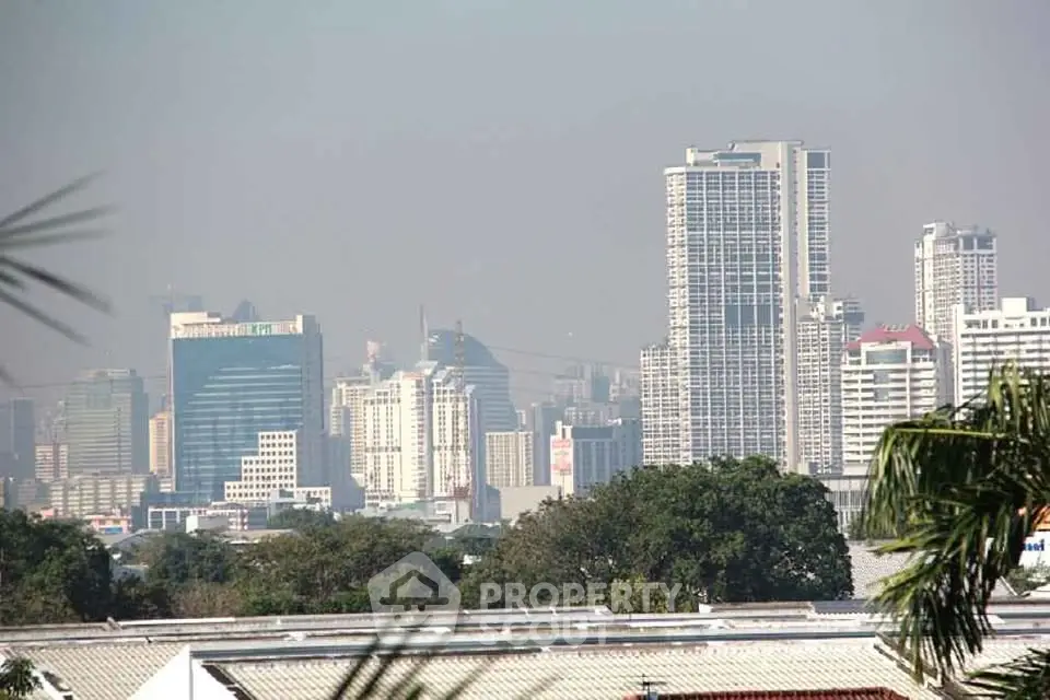 Stunning cityscape view showcasing modern skyscrapers and lush greenery, perfect for urban living enthusiasts.