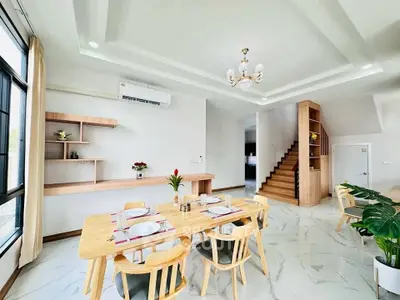 Spacious modern dining area with elegant wooden furniture and stylish decor