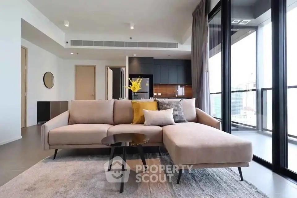 Modern living room with stylish sofa and city view balcony in luxury apartment.