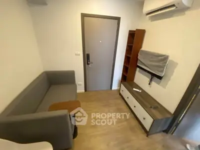 Cozy living room with modern furniture and air conditioning in a compact apartment.