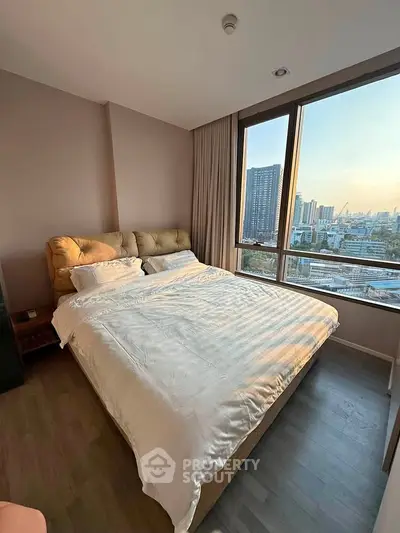Spacious bedroom with city view in modern apartment
