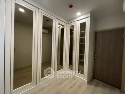 Spacious walk-in closet with mirrored doors and ample storage space