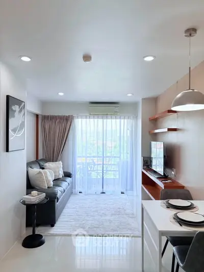 Modern living room with sleek design, featuring a cozy sofa, stylish decor, and a large window with a view.