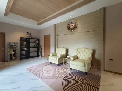 Elegant living room with modern decor and plush armchairs