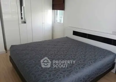 Modern bedroom with sleek design and ample storage in a contemporary apartment.