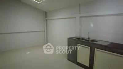 Minimalist kitchen space with dual sink and sleek countertops