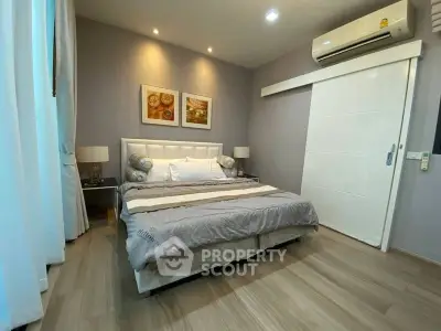 Modern bedroom with elegant decor and air conditioning in a stylish apartment.