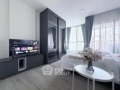 Modern bedroom with sleek design, large windows, and stylish decor for a comfortable living experience.