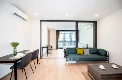 Modern open-plan living room with stylish furniture and natural light