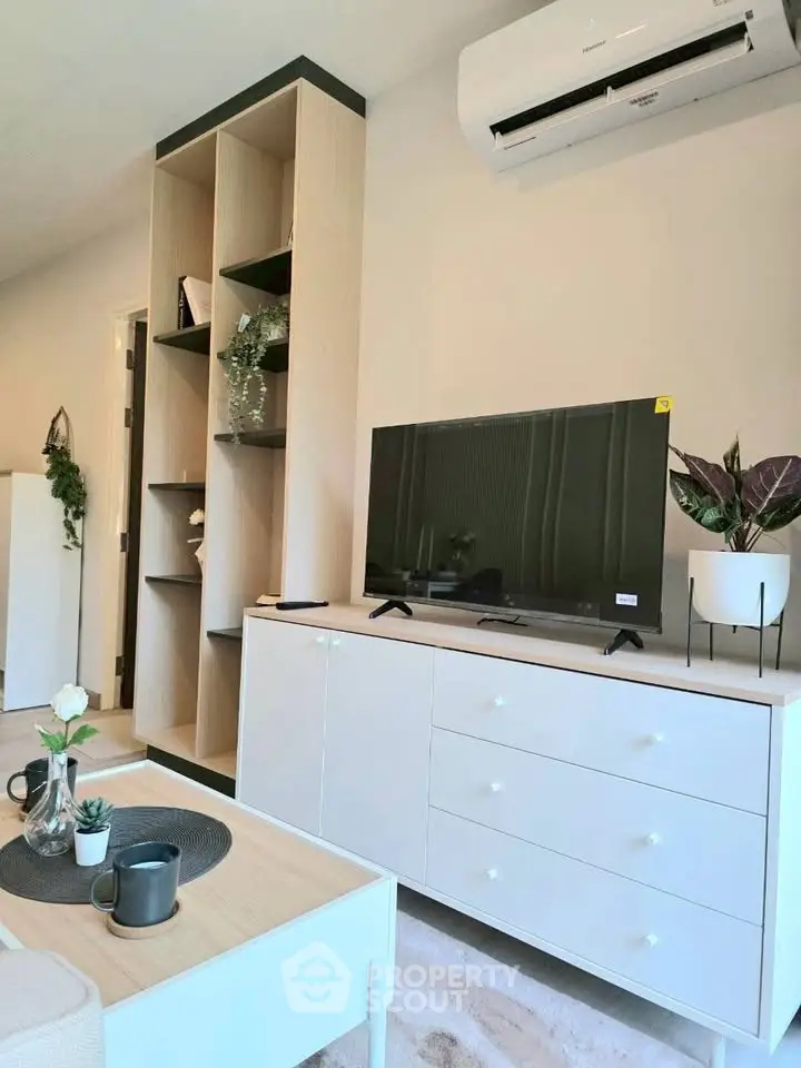 Modern living room with sleek TV unit, air conditioning, and stylish decor