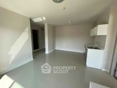 Spacious modern living room with sleek open kitchen in bright apartment