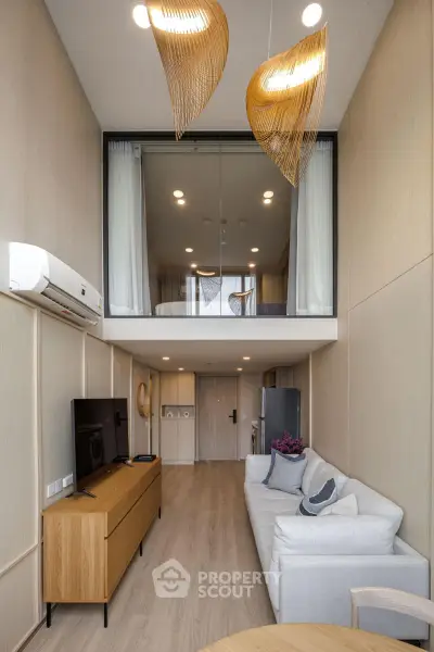 Modern duplex living room with stylish decor and mezzanine bedroom