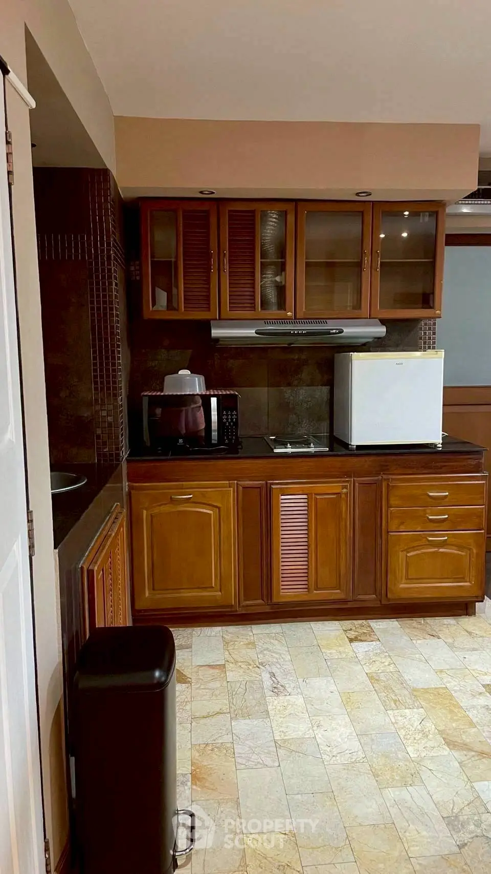 Charming kitchen with wooden cabinets and modern appliances, perfect for culinary enthusiasts.