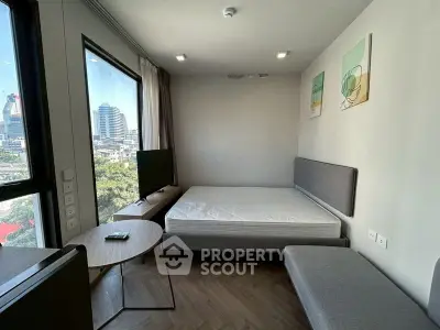 Modern bedroom with city view, featuring a cozy bed and stylish decor.