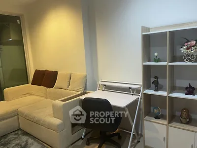 Cozy living room with sectional sofa and study desk, perfect for relaxation and work.