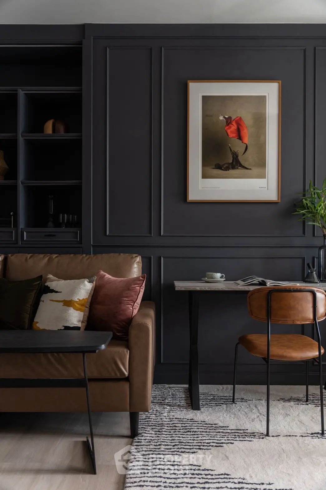 Stylish living room with dark panel walls, leather sofa, and modern art decor.