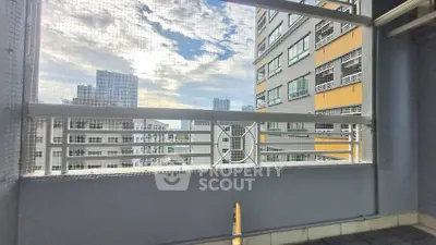 Modern high-rise balcony with city view and safety netting