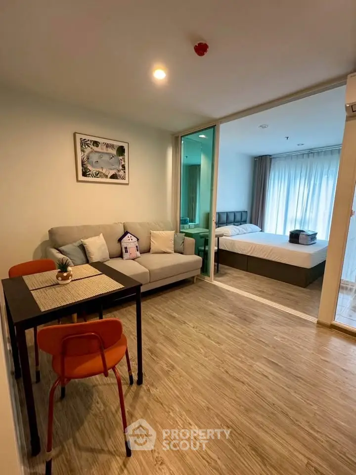 Modern apartment with cozy living room and bedroom, featuring stylish decor and natural light.